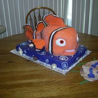Finding Nemo fondandt covered ,hand sculpted, Nemo, swimming on the ocean bed.