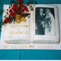 Golden Wedding Cake This cake was made from maderia sponge and made in a book cake tin .Photo copied onto a sheet of icing and Roses made ofpetal paste.