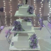 Purple Easter Lilies 6" American chocolate, 8" butter and and 11" almond semolina cake make up thia ensemble.