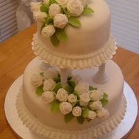 Wilton Course 3 Final Cake This is a white cake with buttercream frosting and white fondant with fondant roses.