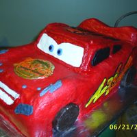 Lightning Mcqueen I made this for a friend of mine. It was my first attempt at carving a cake and I frosted it in a buttercream.
