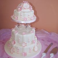 Wedding Cake 3 tier round sponge shimmering bands of paste and flowers arranged around each tier to create a cascading effect