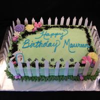 Gardener's Birthday Cake A cake for a gardener with a puppy that gets into everything! The fence is made from MMF and gum paste; all flowers are made from royal...