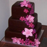 Brown And Pink Wedding Cake Chocolatey brown square wedding cake, 10, 8, 6, covered in fondant and embellished with handcrafted fondant flowers in pink, fuschia and...