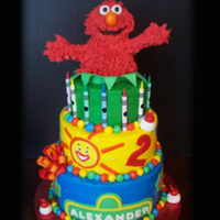 Elmo Cake An Elmo themed cake for a little boys 2nd birthday. Elmo is RKT decorated with royal icing "fur", cake is frosted in buttercream...