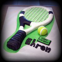 Tennis Racket And Ball Cake Hand carved tennis racket, fondant decorations and fondant ball.