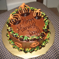 Happy Harvest Day! Chocolate cake, chocolate buttercream frosting with ganache trim and orange chocolate piped pumpkins. Yummy!