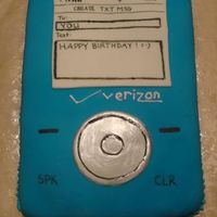 Lg Blue Chocolate Cell Phone Birthday Cake LG Blue Chocolate Cell Phone Birthday Cake. White cake with fondant accents.