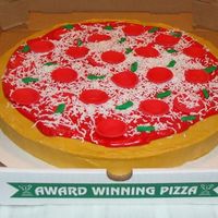 Pizza Cake Chocolate cake. Buttercream icing. Fondant accents. Grated fondant w/ cheese grater.