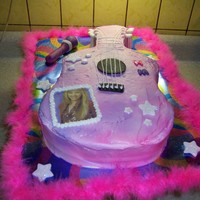 Hanna Motana Guitar Cake This cake is yellow cake, strawberry filing and buttercream frosting. I used food color spray to get the tyed look. The mic and stars are...