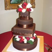 "dorthy" My second go at a wedding cake...for my cousin's reception earlier this month that served 150 guests. Alternating round and square...