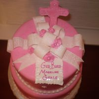Madeline Grace's Christening 10 and 8 inch white cake filled with Cannoli cream and Chocolate Mouse. Cake was covered in Chocolate Ganache and then Fondant. Bow, Cross...