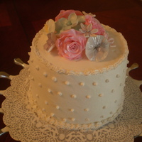 Mommie's Birthday Cake Vanilla Chiffon Cake with Lemon Curd covered in buttercream with gumpaste flowers.
