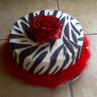 Zebra.jpg 10" 2 layer white cake, fresh strawberry filling. Buttercream icing with MMF accents. Made for a coworkers birthday.