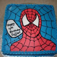 Spiderman Cake Made for my son's birthday. Spiderman is made out of red fondant, cake is covered with blue buttercream, web is made with black piping...