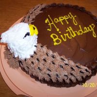 Eagle round cake with cupcake for eagle head. Use of grass tip for wings and star tip for head.