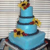 Creative Bride Four tiered strawberry cake with orange buttercream. Fondant was Pettinice which is DELICIOUS! Had a hard time covering the 14" square...