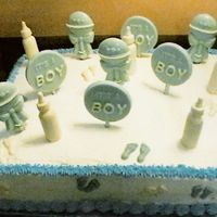 First Baby Shower Cake I made this cake for my daughter's teacher. It is 2-layer dark fudge chocolate cake with BC icing, the bottles, footprint, rattles,...