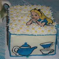 Alice In Wonderland Pineapple cake frosted in buttercream. Flowers are RI and the Alice and teacup/pot images are color flow. Thanks for looking!