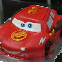 Lightning Mcqueen 2layers of vanilla cake carved to make it look like lightning mcqueen. covered with gumpaste. all other details were also gumpaste.