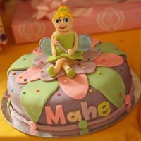 Tinkerbell Cake I made this cake for my friend's daughter. It's my version of tinkerbell. Used gumpaste for the tinkerbell, flower & leaves;...