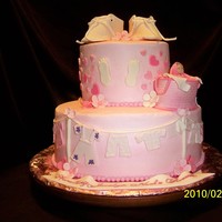 Wash Day With Baby Shoes all decoration made of fondant white cake with strawberry slices between layers with buttercream icing