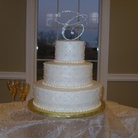 Quilted Pearls & Rhinestones Wedding Cake Ivory quilted pattern with edible pearls and a rhinestone topper.