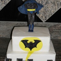 Batman Cake 2 tier cake iced in buttercream. Decorations and batman are marshmallow fondant