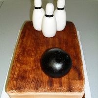 Bowling Lane Cake 1/4 sheet cake with buttercream frosting airbrushed to look like a bowling lane and fondant bowling ball and pins.