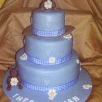 Blue Christening Cake 3 tier chocolate cake with chocolate buttercream filling covered in blue fondant. The bears, flowers and letters are made with modelling...