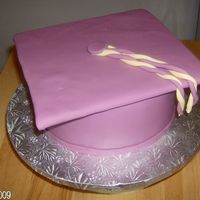 Graduationcap This is two 8" carved a bit at the top & covered in si fondant. The cake is marble with bc filling. Cap is cardboard covered in...