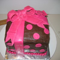 First Present/bow Cake 3 - 8" square cakes staked and covered w/ Chocolate BC. Fondant ribbon & bow. This was my first time working w/ fondant :) ... TFL...