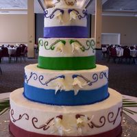 100_4428.jpg Lots of colors...iced in buttercream, RI and Fondant accents