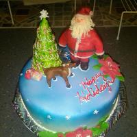 Santa And Rudolf Cake Santa and Christmas tree made of rice crispy treats covered in vanilla choc clay, rudolf made of choc modelling clay, the cake is Hershey&#...