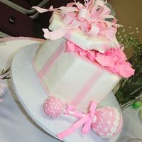 Tiff's Baby Shower Cake butter cake with butter cream icing covered in MMF with gumpaste bow. Rattle is RKT covered in MMF.