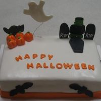 Happy Halloween Simple fun Halloween cake for my co-workers. I made the pumkins myself out of fondant.