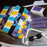 Gift Bag Cake Cake was funfetti filled with buttercream, covered in MMF. All accents were MMF.I wasn't crazy about the color scheme but really didn...