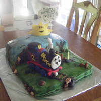 Thomas The Train Birthday cake for 2 year old. Banana cake with vanilla buttercream filling. train and sun made from fondant with airbrush designs