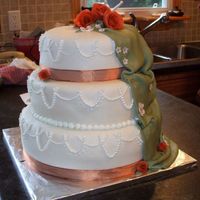 Fall Wedding This was made for a fall wedding of a family friend. Carrot cake, cream cheese icing, covered in MMF, with fondant roses brushed with pearl...