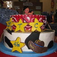 Cowboy baby shower cake in a western theme, with cow print and bandana print