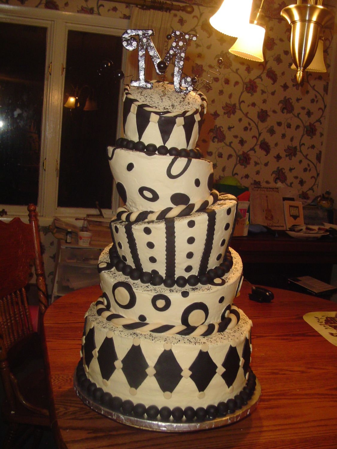 Black And Ivory Topsy Turvy Ivory buttercream, ivory and black fondant, topper was made out of foam core board