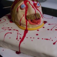 Practice Cake Lemon cake with lemon bc convered in MMF. Practice for a severed head on a platter cake I am doing for a hallloween party.