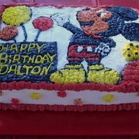 Mickey Brings A Gift This is a chocolate cake with buttercream icing. I drew the Mickey, flowers & gift by a coloring book picture and then filled them in...