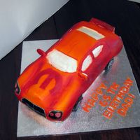 Dodge Charger With the Mopar logo for a man who works for them. Modeling chocolate, fondant, airbrushed.