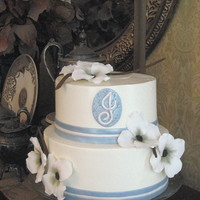Dogwood Flowers Shower Cake Gumpaste dogwood flowers made without wires. Blue fondant accents lustered with Super Pearl. Swiss meringue buttercream.