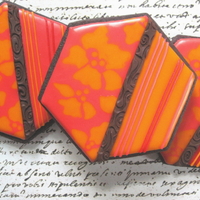 Hot Color Hibiscus Cookies Flower pattern was done wet-on-wet, stripes were over-piped, and and center stripe is impressed modelling chocolate. Glace icing on dark...