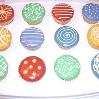 Mod Cupcakes Lemon cupcakes with dipped fondant icing and royal accents.