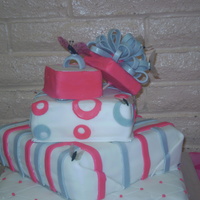 Ari's Present Cake This cake was a 4 tier present cake and the butterfly was gelatin everything else was fondant.