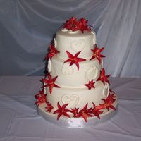 Tiger Lily Wedding This cake was for the son of my Husband's boss. Choco-pan fondant, fake flowers provided by the bride.