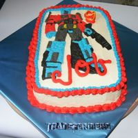 Transformers Birthday Cake Chocolate cake (Hershey's version), Bavarian cream filling, vanilla buttercream frosting. Made design using rice paper transfer of...